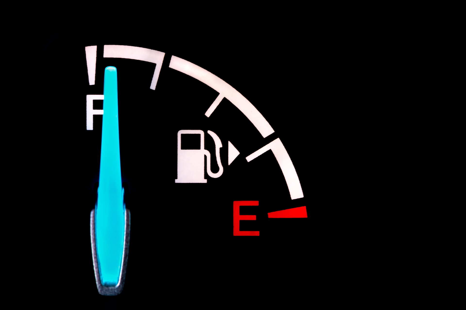 Fuel gauge on dashboard of car. Fuel economy, carbon footprint and price of gasoline concept